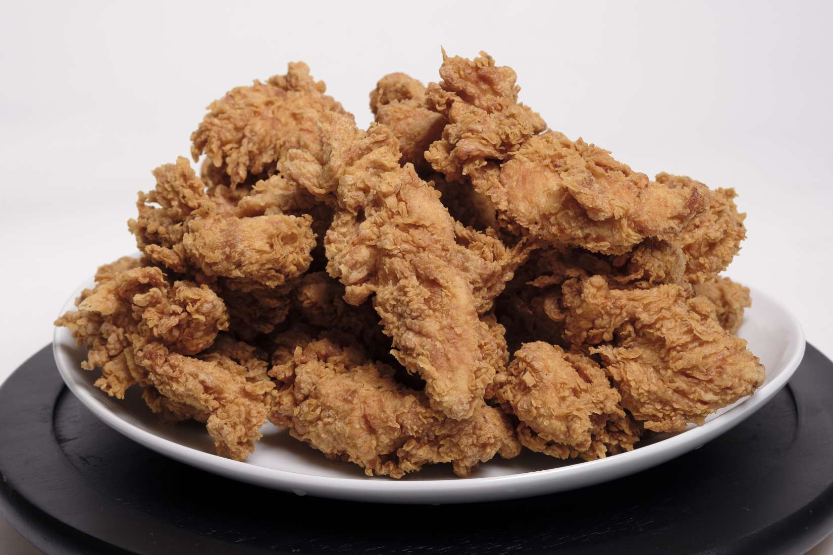 Crispy fried chicken on a white plate.